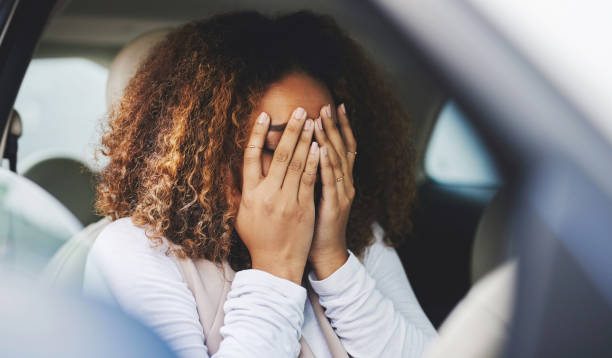 Cropped shot of a young woman looking stressed-out with anxiety while sitting in her car. Chiropractor appointment